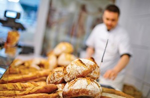 Traditional bread close up with baker at the backgorund