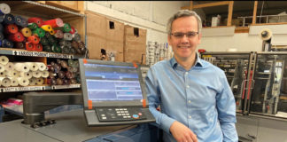 man standing by screen in shop