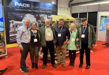 Firms mark 30 years of working together with new potato packing line Group photo in front on packaging machinery