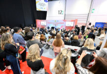 Conference session with speakers on stage