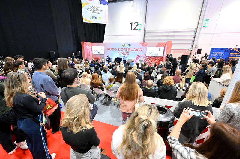Conference session with speakers on stage