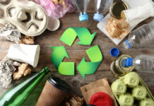 New Valpak service aims to help businesses prepare for PPWR Recycling symbol and different garbage on wooden background, top view