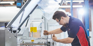 Engineer maintaining packaging machinery