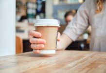 First behavioural systems map focussed specifically on cup recycling to be created Paper cup being placed on table