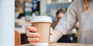 Paper cup being placed on table