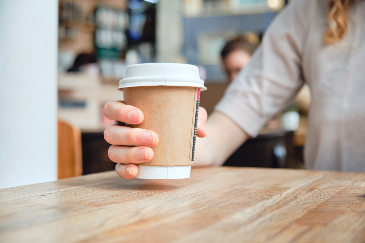 Paper cup being placed on table
