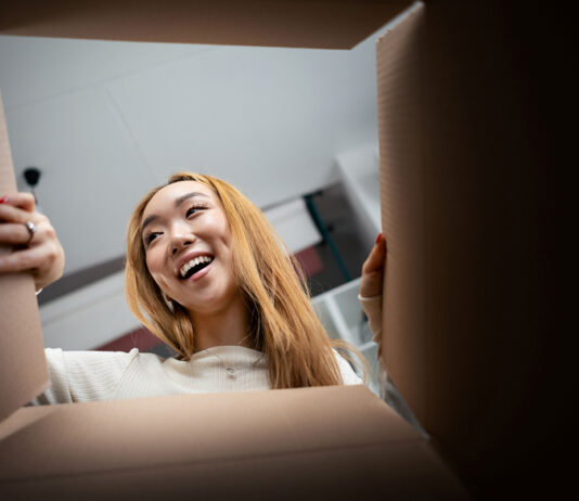 Consumer opening a box. Unboxing image