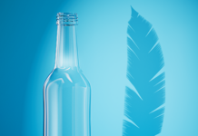 Empty glass bottle next to a feather to depict lightness