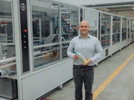Fruglapac Product Director JP Grogan and the new Frugal Bottle Assembly Machine 2 (FBAM-2)