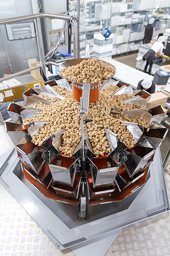 Ishida multihead weigher in production facility weighing popcorn