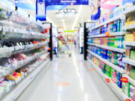 Supermarket in blurry background displaying various types of packaging