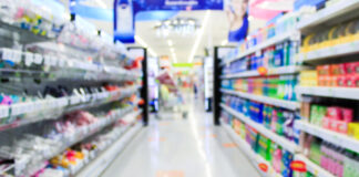 Supermarket in blurry background displaying various types of packaging